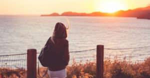 Woman standing alone on a large wooden pier