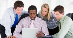 Employees looking at a computer - we are here to help